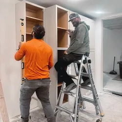 Expert leveling while installing new custom cabinets in a home